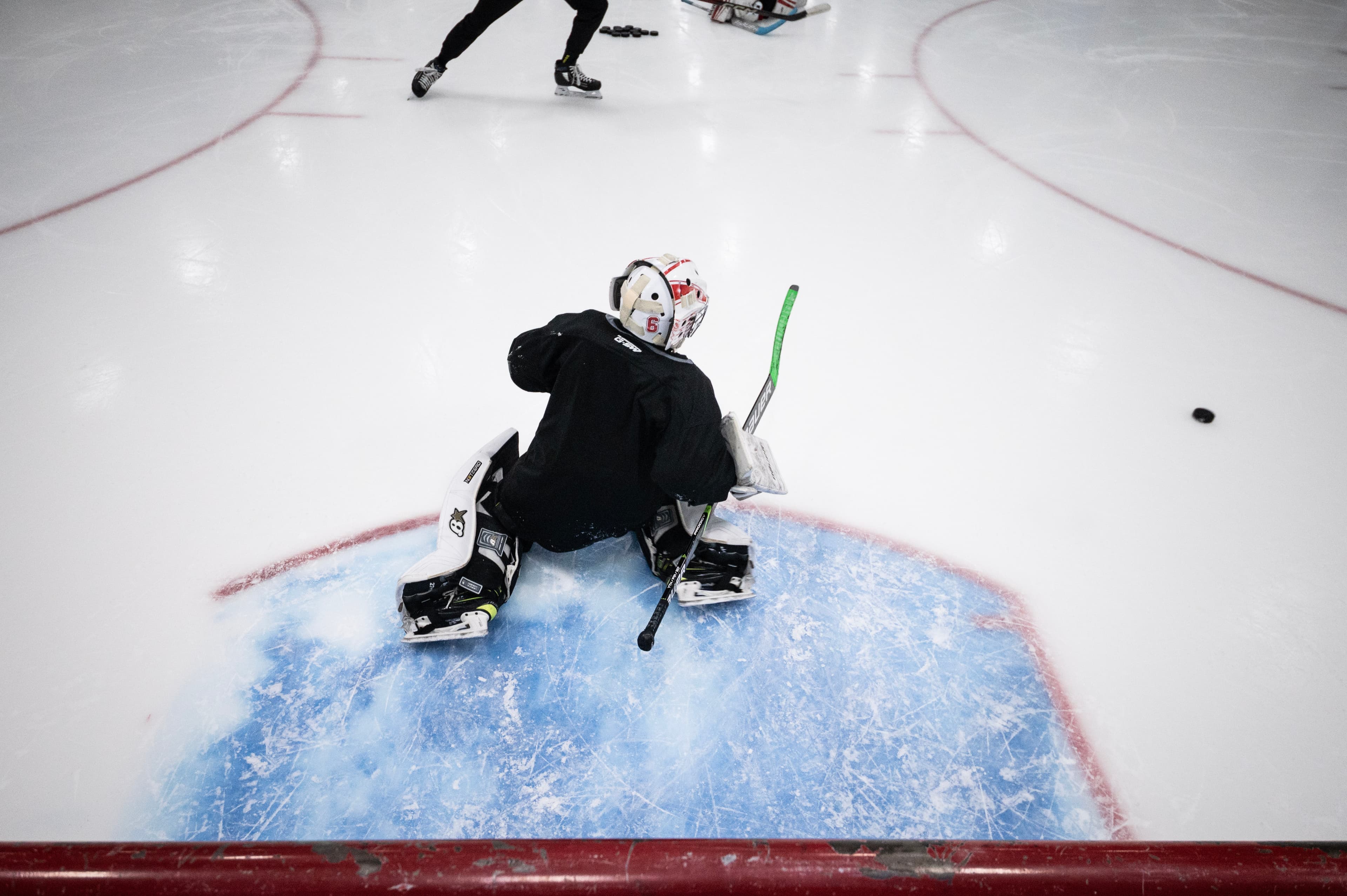 Goalie in butterfly on practice ice