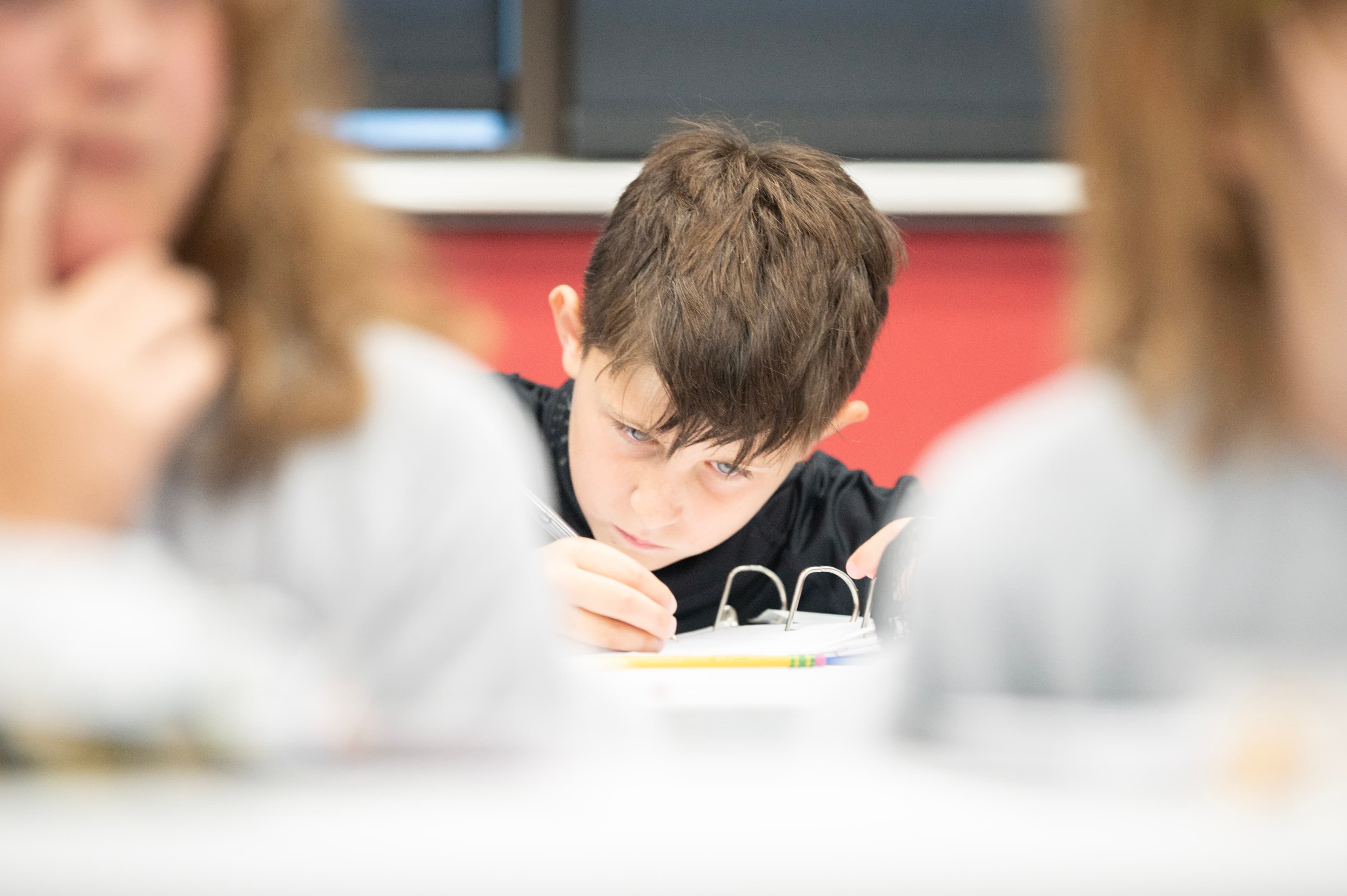 Goalie writing in a journal during a classroom session