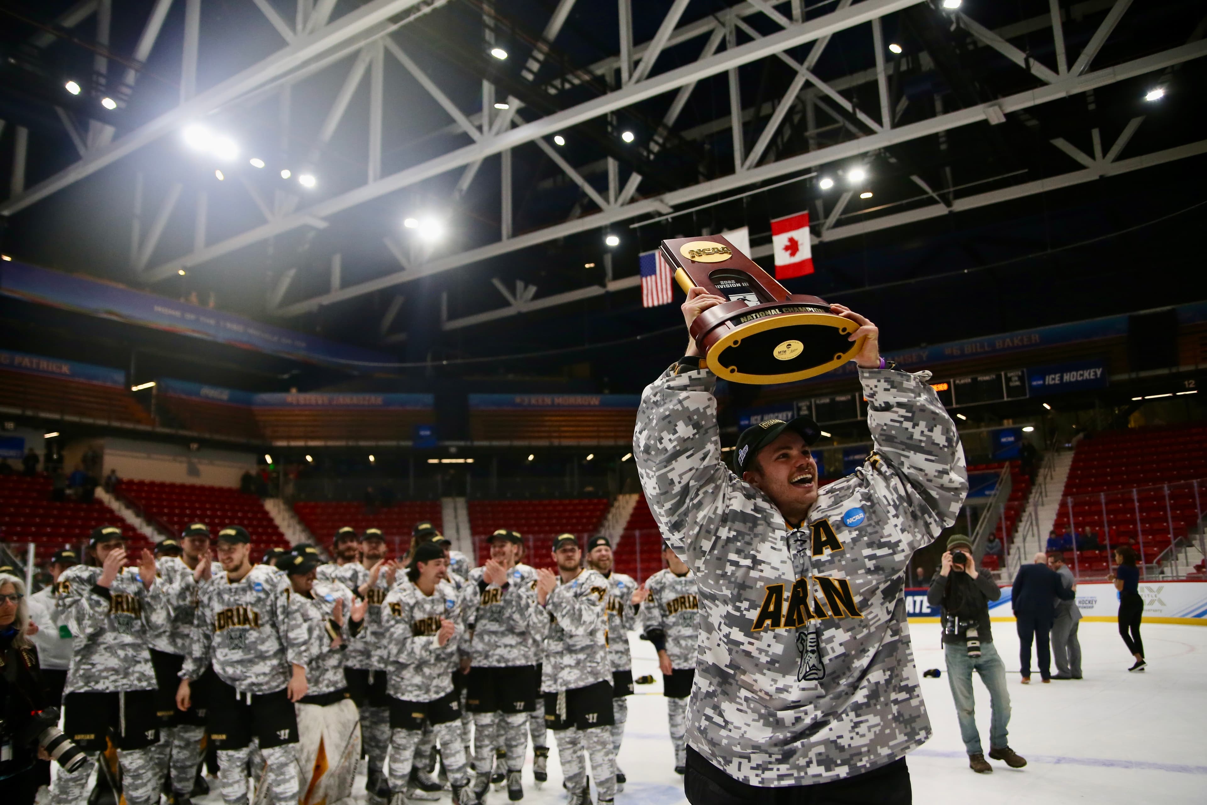 Cam Gray hoisting the NCAA Division III National Championship trophy with the Adrian College team